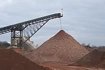 Upwards loading conveyor creating a huge mound of limestone.