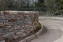 Curved wall made of random walling stone.