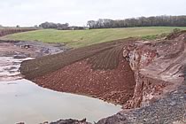 Recently turfed bank in spent quarry.